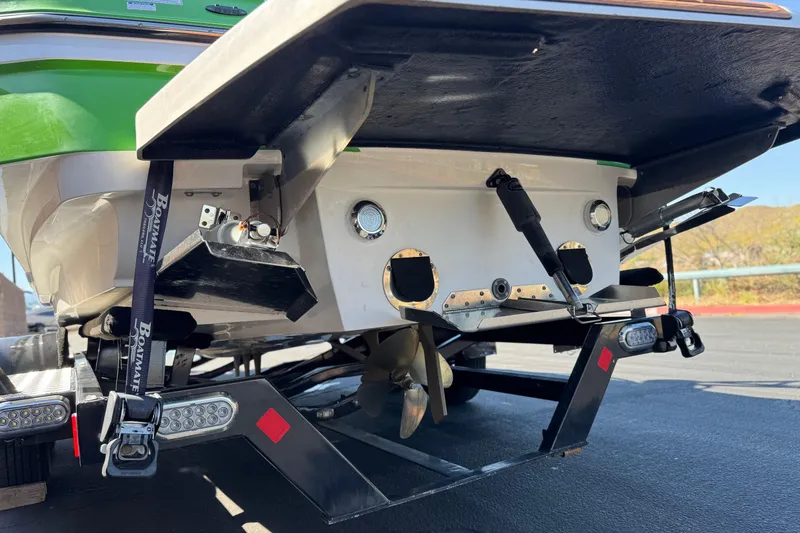 Slide: The Image of Rear view of a 2013 MasterCraft XStar boat on a trailer, showcasing propeller and trim tabs. - 8