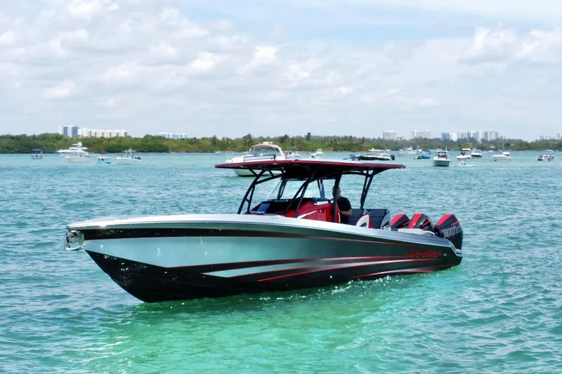 The Image of 2024 Nor-Tech 340 Sport Center Console boat on clear blue water. - 0