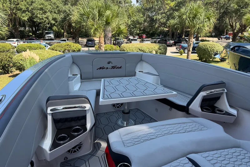 Slide: The Image of 2024 Nor-Tech 340 Sport Center Console boat interior with seating and table. - 5