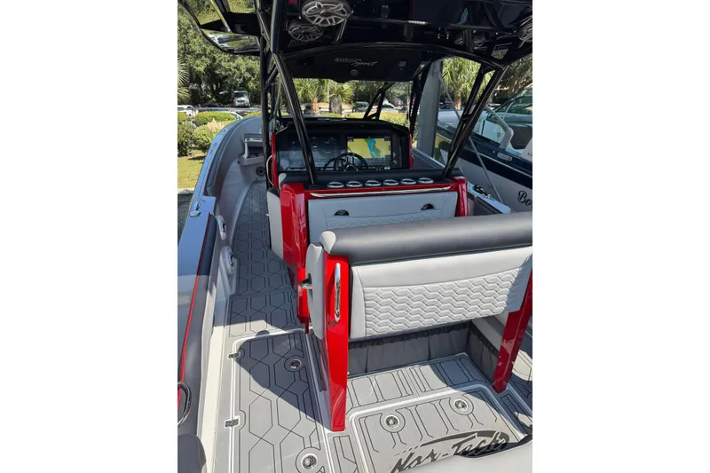 Slide: The Image of 2024 Nor-Tech 340 Sport Center Console boat interior with modern seating and navigation system. - 7
