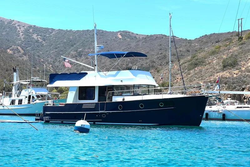 The Image of 2015 Beneteau Swift Trawler 44 anchored in scenic coastal waters. - 0