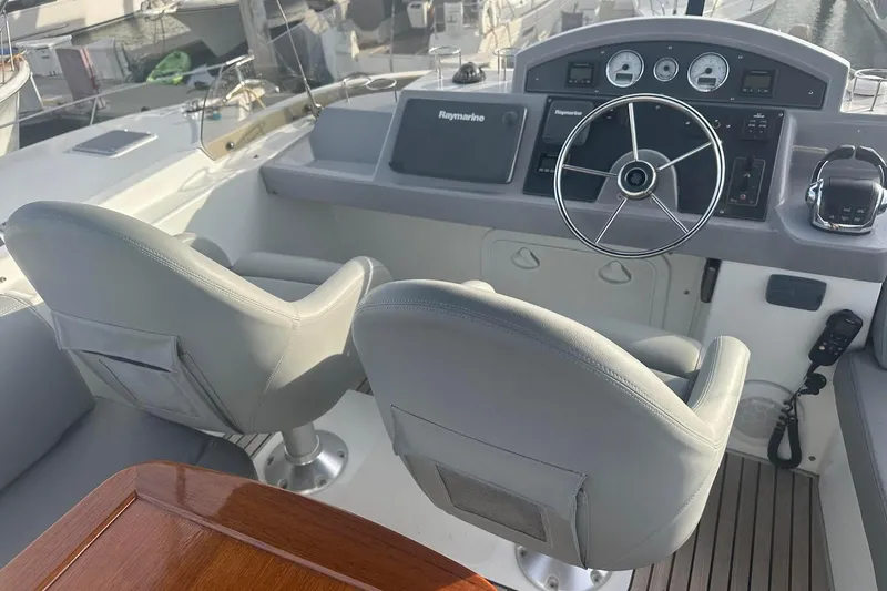 Slide: The Image of Helm of 2015 Beneteau Swift Trawler 44 with dual seats and navigation controls. - 18