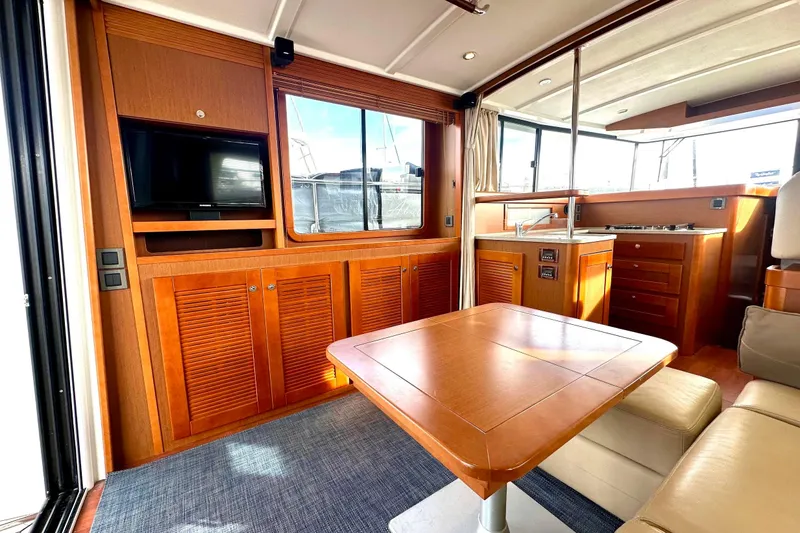 Slide: The Image of Interior of 2015 Beneteau Swift Trawler 44 with wood cabinetry and modern amenities. - 33