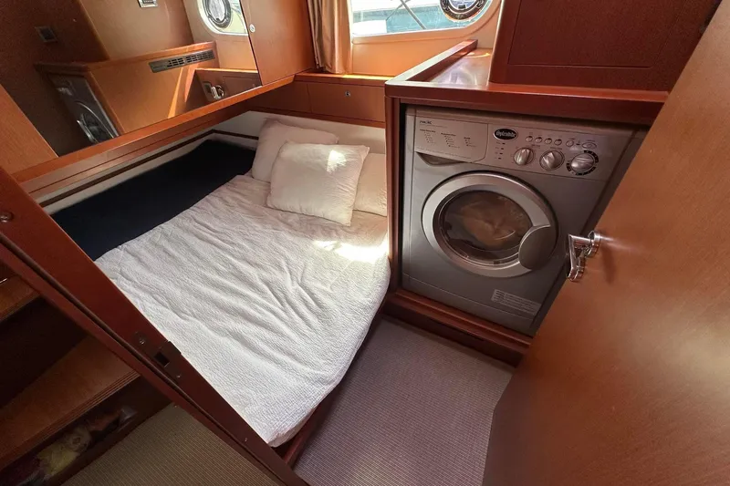 Slide: The Image of Cozy cabin with bed and washer in 2015 Beneteau Swift Trawler 44 yacht. - 35