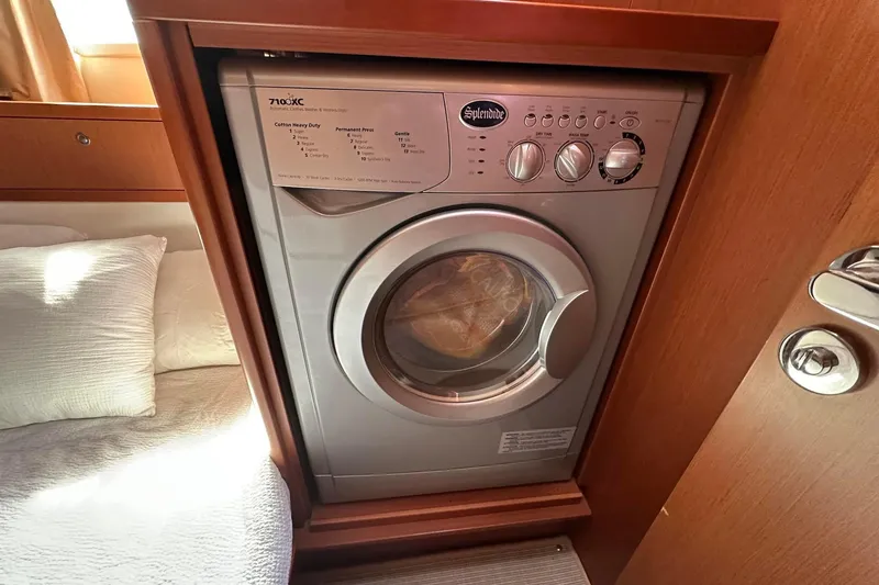 Slide: The Image of Washing machine inside 2015 Beneteau Swift Trawler 44 cabin, next to bed. - 36