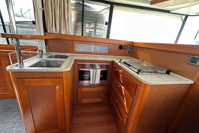 Slide: The Image of Interior view of 2015 Beneteau Swift Trawler 44 kitchen with sink and stove. - 38