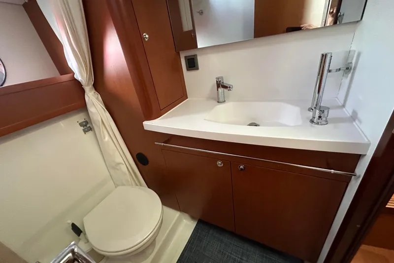 Slide: The Image of 2015 Beneteau Swift Trawler 44 bathroom with modern sink and toilet. - 39