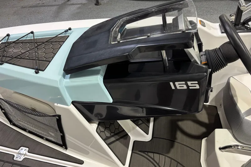 Slide: The Image of 2023 Scarab 165 ID boat interior with dashboard and seating details. - 11