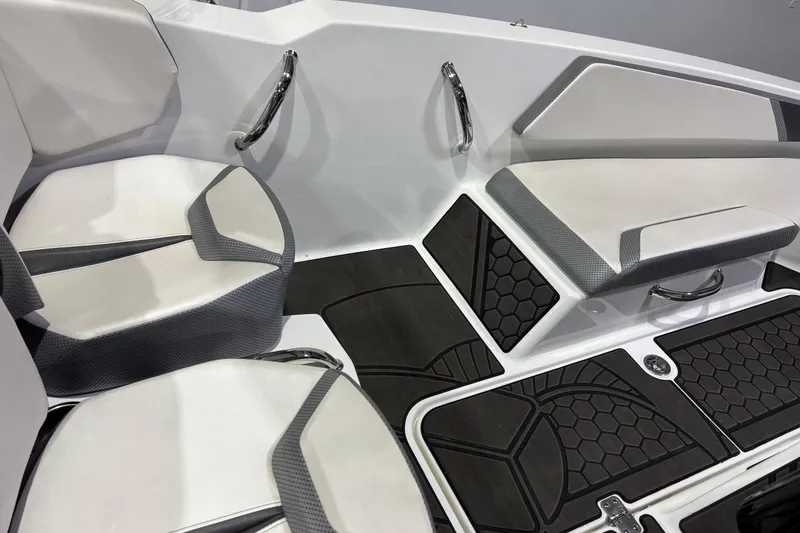Slide: The Image of 2023 Scarab 165 ID boat interior with white and gray seating and black flooring. - 12
