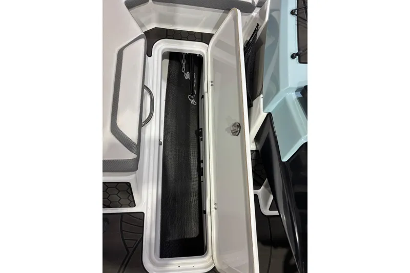 Slide: The Image of Open storage compartment on 2023 Scarab 165 ID boat, showcasing interior design. - 14