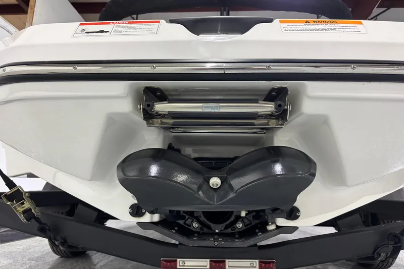 Slide: The Image of Rear view of 2023 Scarab 165 ID boat on trailer, showcasing engine and hull design. - 15