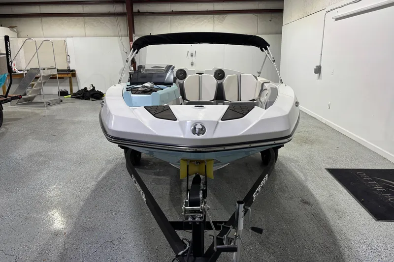 Slide: The Image of 2023 Scarab 165 ID boat in showroom, front view, on trailer. - 4