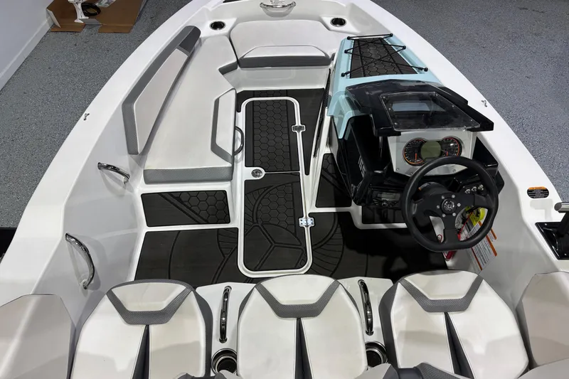 Slide: The Image of 2023 Scarab 165 ID boat interior with modern dashboard and seating arrangement. - 5