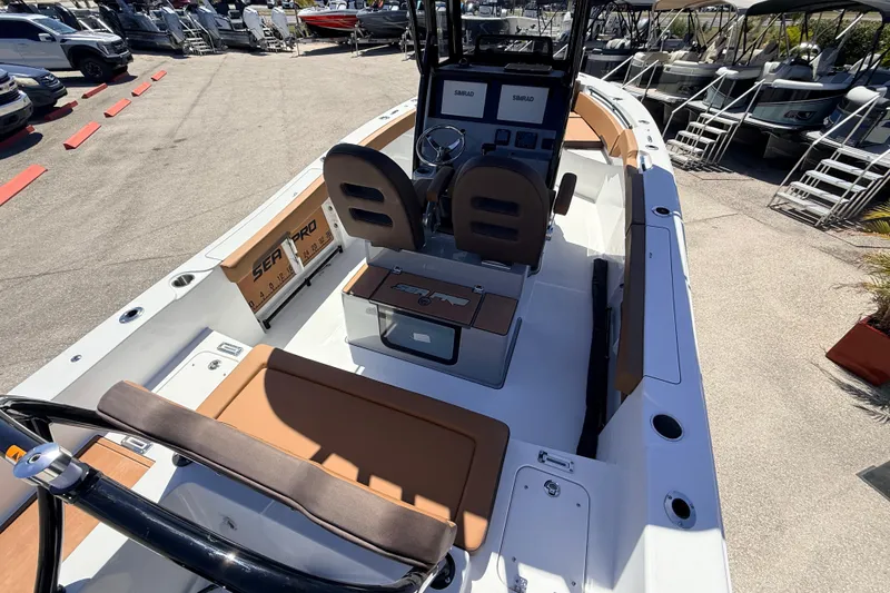Slide: The Image of 2026 Sea Pro 245FLXR Sandbar boat interior with seating and control panel. - 12
