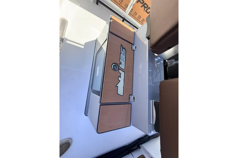 Slide: The Image of 2026 Sea Pro 245FLXR Sandbar boat interior with storage compartment. - 13