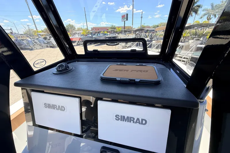 Slide: The Image of 2026 Sea Pro 245FLXR Sandbar boat dashboard with Simrad displays and compass. - 17