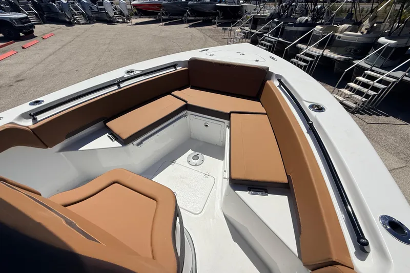 Slide: The Image of 2026 Sea Pro 245FLXR Sandbar boat with tan seating in a showroom. - 18