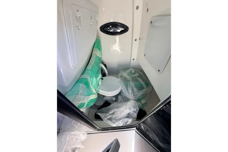 Slide: The Image of Interior of 2026 Sea Pro 245FLXR Sandbar boat, featuring compact storage space. - 28