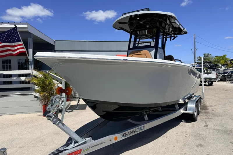 Slide: The Image of 2026 Sea Pro 245FLXR Sandbar boat on trailer, displayed outdoors under clear blue sky. - 3