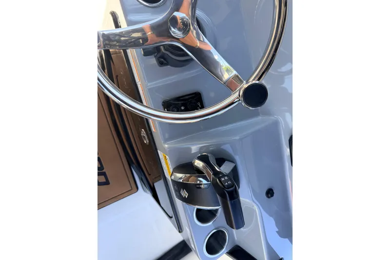 Slide: The Image of Steering wheel and controls of 2026 Sea Pro 245FLXR Sandbar boat. - 31