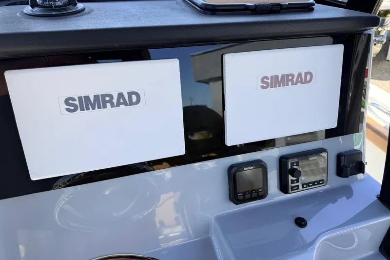 Slide: The Image of Dashboard of 2026 Sea Pro 245FLXR Sandbar with Simrad navigation displays. - 32