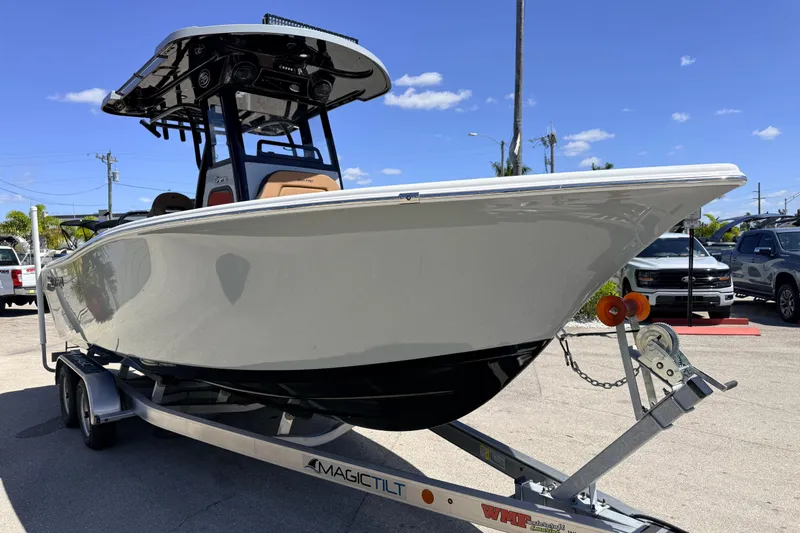 Slide: The Image of 2026 Sea Pro 245FLXR Sandbar boat on trailer under clear blue sky. - 5