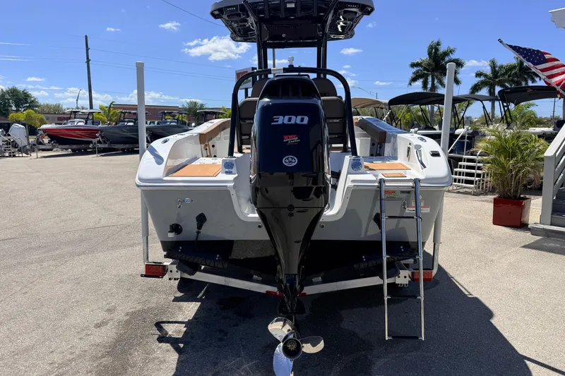 Slide: The Image of 2026 Sea Pro 245FLXR Sandbar boat with powerful 300 HP engine, docked under clear skies. - 7