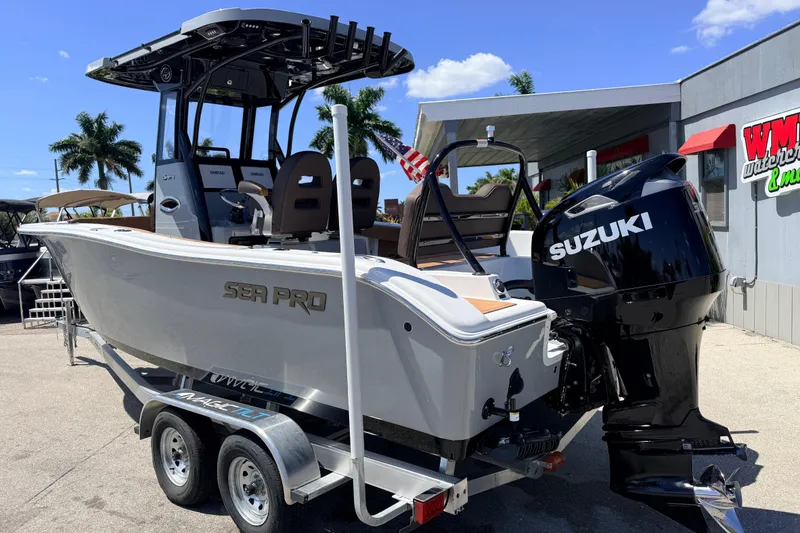 Slide: The Image of 2026 Sea Pro 245FLXR Sandbar boat with Suzuki engine on trailer, outdoor display. - 9