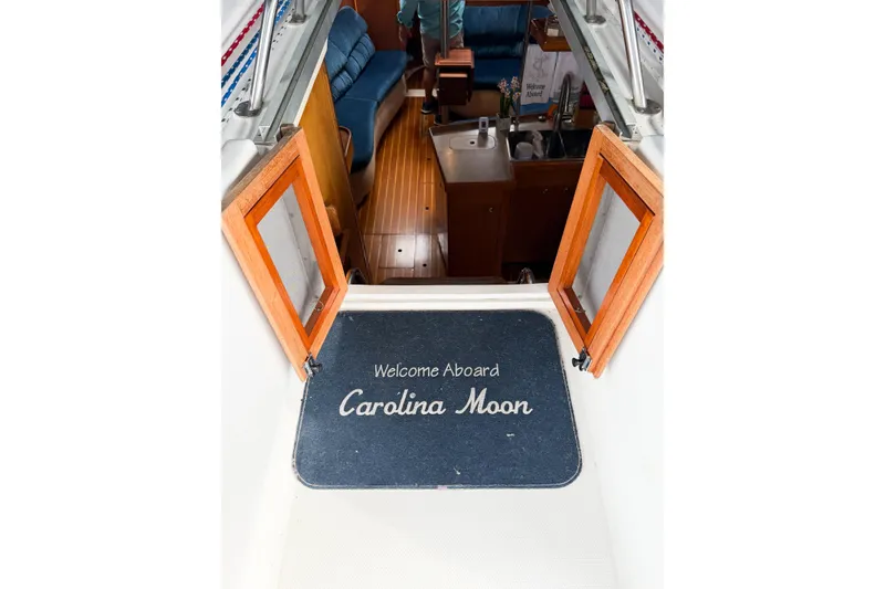 Slide: The Image of Welcome mat on 2002 Hunter 380 sailboat, "Carolina Moon," with open cabin doors. - 12