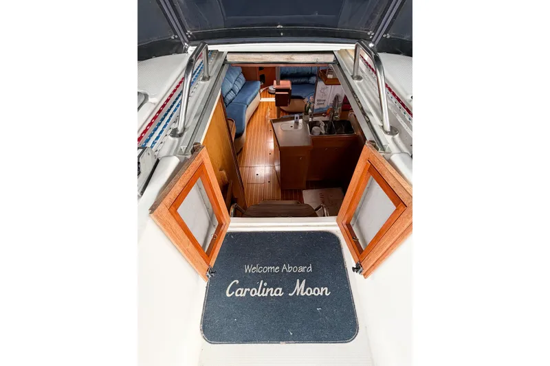 Slide: The Image of Interior view of 2002 Hunter 380 sailboat, featuring cozy cabin and kitchenette. - 13