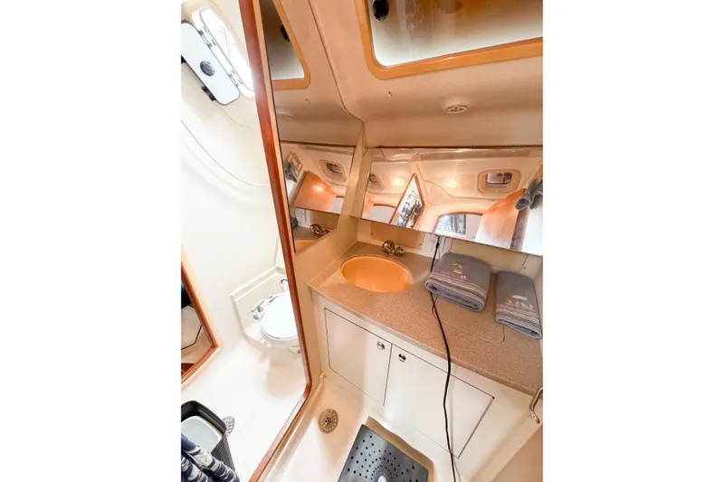 Slide: The Image of Bathroom interior of 2002 Hunter 380 yacht with sink, mirror, and towels. - 21