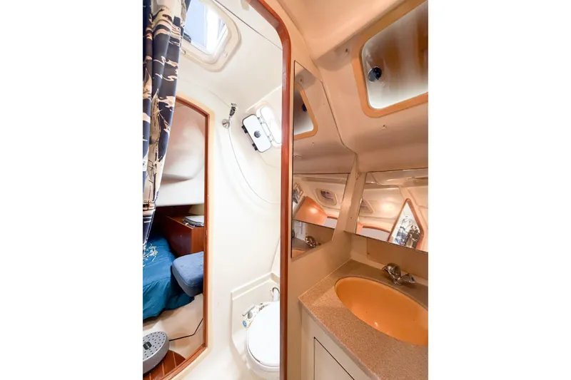 Slide: The Image of Interior of 2002 Hunter 380 yacht showing bathroom and cabin area. - 22
