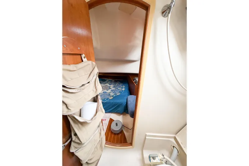 Slide: The Image of Interior cabin view of a 2002 Hunter 380 sailboat, featuring a cozy sleeping area. - 24