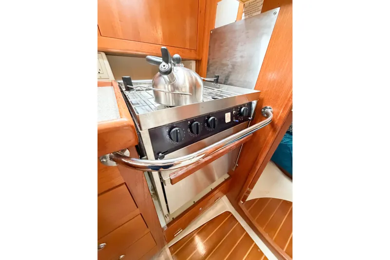 Slide: The Image of Compact kitchen stove with kettle in 2002 Hunter 380 sailboat galley. - 28