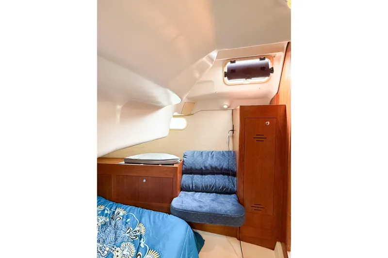 Slide: The Image of Interior cabin of 2002 Hunter 380 yacht with blue seating and wooden cabinetry. - 34