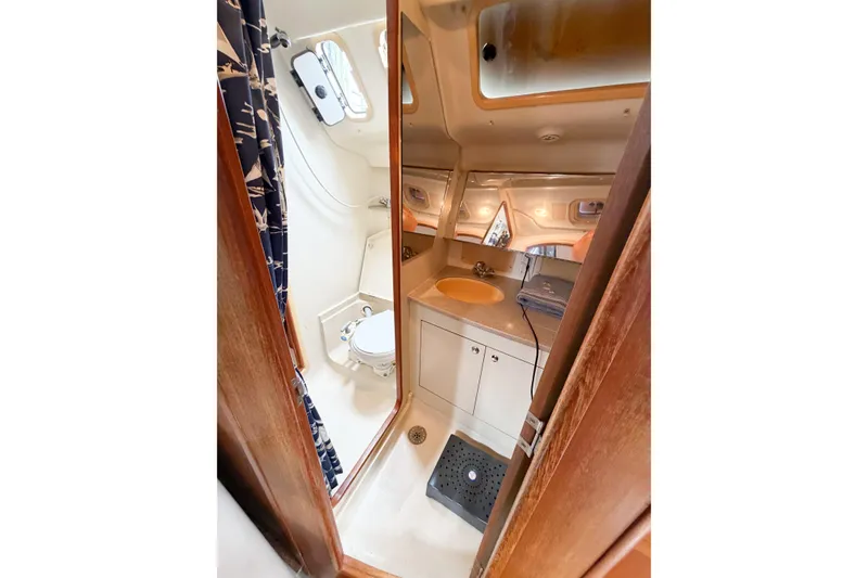 Slide: The Image of Interior of 2002 Hunter 380 yacht bathroom with sink, toilet, and shower. - 36