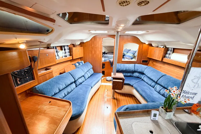 Slide: The Image of Interior of a 2002 Hunter 380 sailboat with cozy seating and wooden finishes. - 38