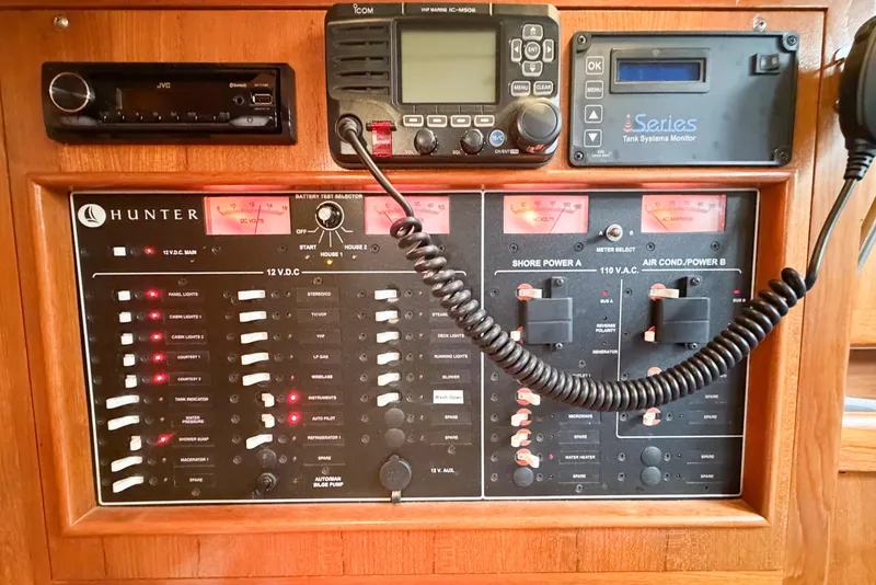 Slide: The Image of Electrical control panel of a 2002 Hunter 380 yacht, featuring various switches and monitors. - 40