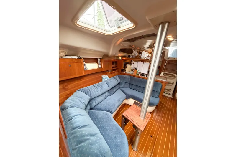 Slide: The Image of Interior of 2002 Hunter 380 sailboat with blue seating and wooden finishes. - 41