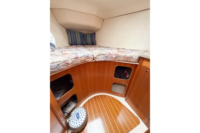 Slide: The Image of Cozy cabin interior of 2002 Hunter 380 sailboat with wooden finish and bedding. - 47
