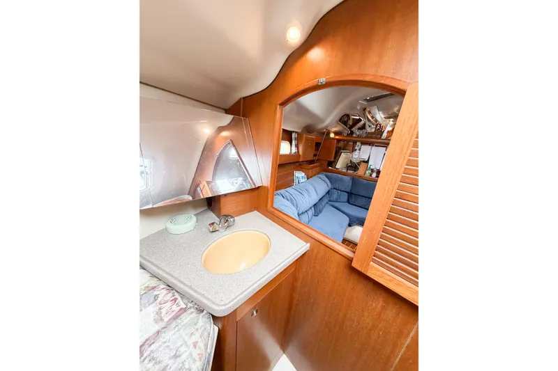 Slide: The Image of Interior of 2002 Hunter 380 yacht with cozy seating and wooden cabinetry. - 49