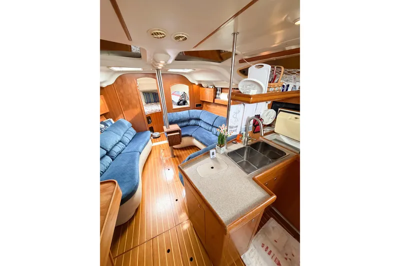 Slide: The Image of Interior of a 2002 Hunter 380 yacht with cozy seating and kitchen area. - 52