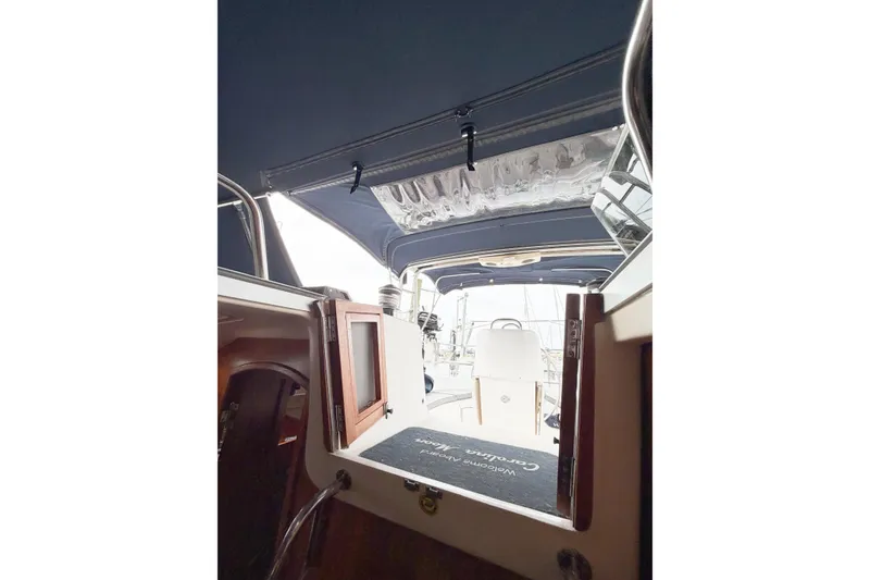 Slide: The Image of Interior view of a 2002 Hunter 380 sailboat, showcasing the cockpit and cabin entrance. - 55