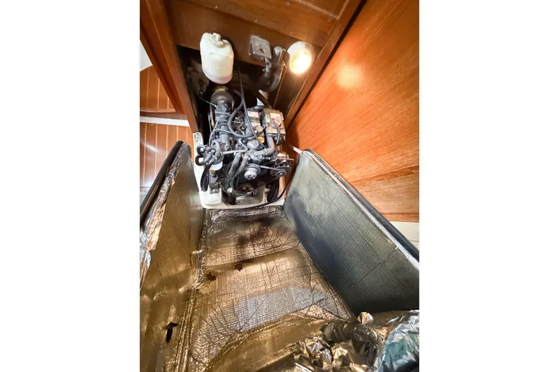 Slide: The Image of Engine compartment of a 2002 Hunter 380 sailboat, showcasing mechanical components and insulation. - 62