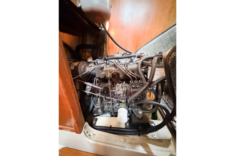 Slide: The Image of Engine compartment of a 2002 Hunter 380 sailboat, showcasing intricate mechanical components. - 63