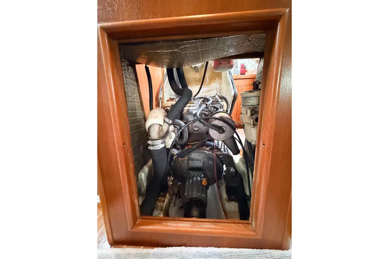 Slide: The Image of Engine compartment of a 2002 Hunter 380 sailboat, showcasing mechanical components. - 64