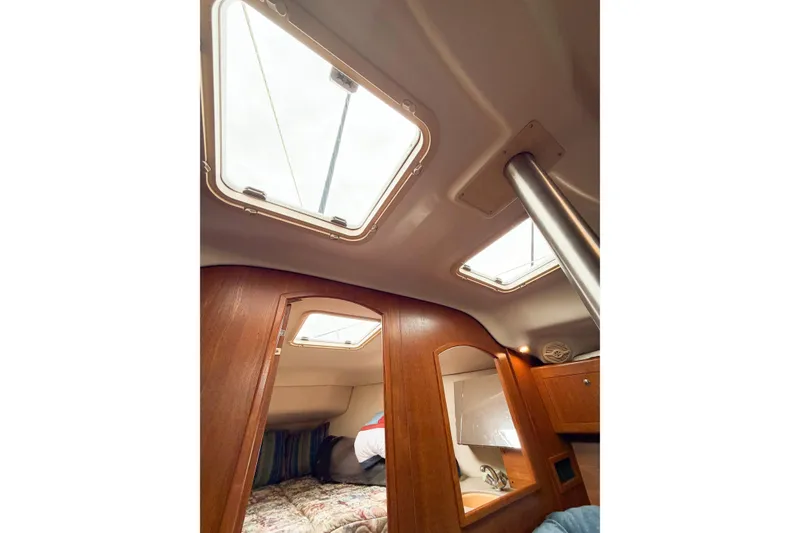 Slide: The Image of Interior cabin of 2002 Hunter 380 sailboat with skylights and wooden finish. - 67