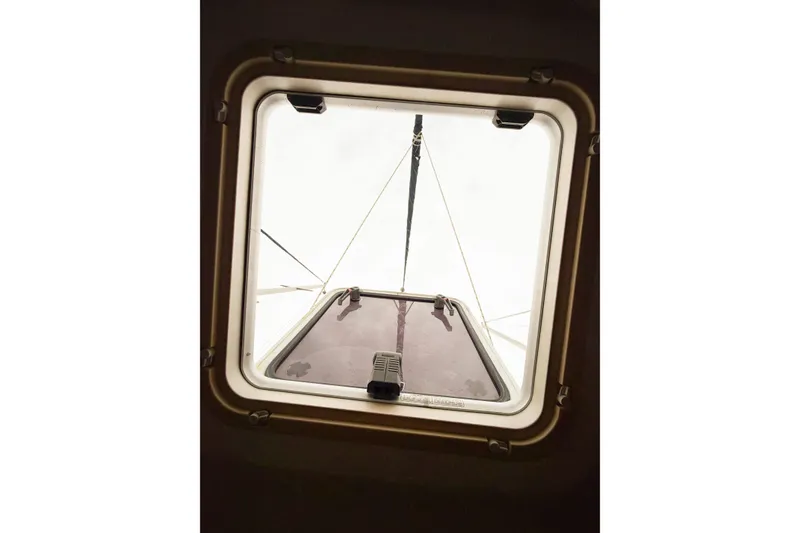 Slide: The Image of View through a hatch on a 2002 Hunter 380 sailboat, showing mast and rigging. - 68