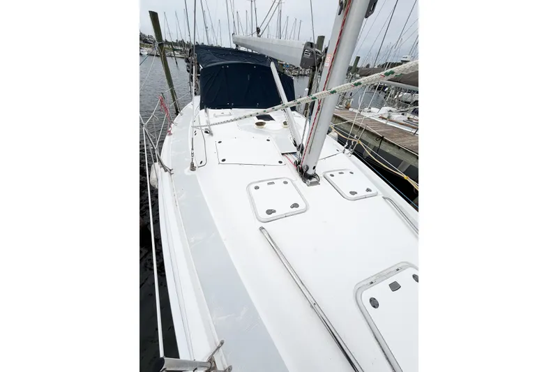 Slide: The Image of 2002 Hunter 380 sailboat deck view at marina, showcasing mast and rigging. - 7