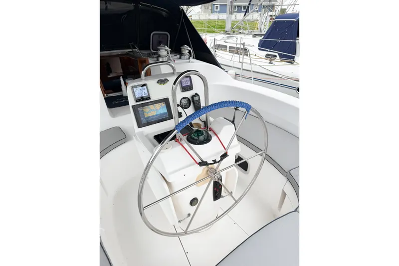 Slide: The Image of Cockpit of 2002 Hunter 380 sailboat with navigation equipment and steering wheel. - 72